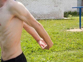 Warm-up before training. The pumped-up guy is warming up. Close-up