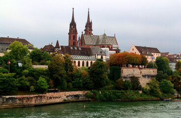 Fototapeta premium View of the Gothic red brick Basel Cathedral and the Rhein River in the city of Basel, northern Switzerland 