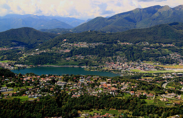 Fototapeta na wymiar Panoramic view of the mountains and Lake Lugano from Mount San Salvatore in the city of Lugano, in southern Switzerland