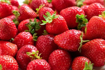 Strawberry on a white background. Strawberry background. Red fresh strawberry wallpaper. Macro. Texture. Frame with copy space. Lots of freshly picked Berries. Close up. Natural Food. Vegetarian