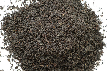 Pile of Black dry Tea on White. Black Tea Leaves rotating on Turntable. Close Up, Macro. Top View....