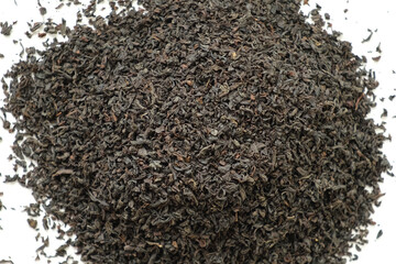 Pile of Black dry Tea on White. Black Tea Leaves rotating on Turntable. Close Up, Macro. Top View. Texture. Full Frame. Copy Space. Dried Tea is Spinning. Abstract Food and Drink Background.