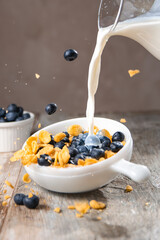 Corn flakes with blueberries and milk for breakfast