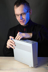 repair of a satellite tuner by a person on a table