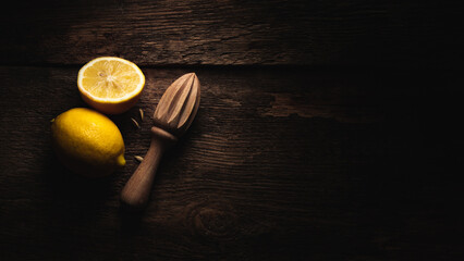 Fresh lemons in dark mood on black background