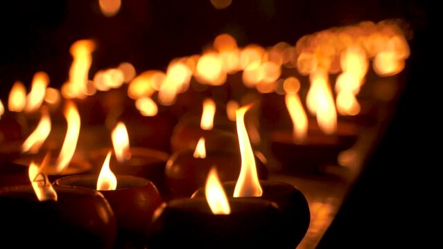 Close Up View Of Oil Candles Burning At Night