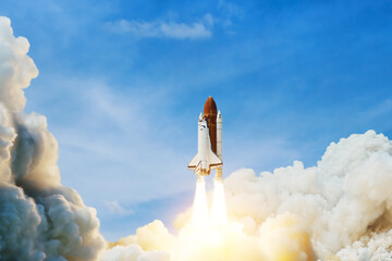 Spaceship lift off. Space shuttle with smoke and blast takes off into space on a background of blue...