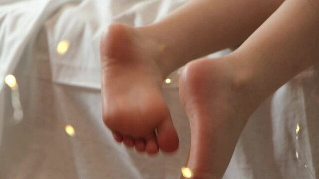 Child feet and flashlights Christmas barefoot concept with copy space. Happy Xmas holiday relax concept. 4k