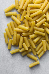 Flat lay of uncooked tortiglioni pasta shells, top view of tortiglioni pasta shells, dry uncooked macaroni