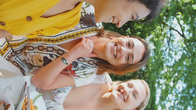 Vertical Video POV Shot Of Three Female Friends Taking Selfie On Mobile Phone Eating Meal Outdoors - Shot In Slow Motion 