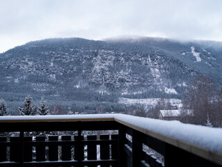 Snowy mountain landscape pictured from a snow-covered porch in Norway