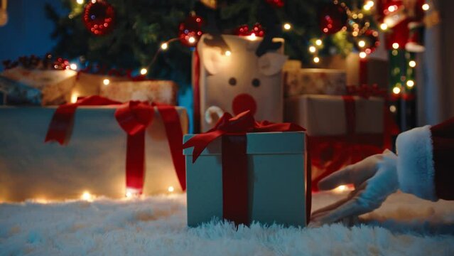 Santa Claus hand with Christmas gift box