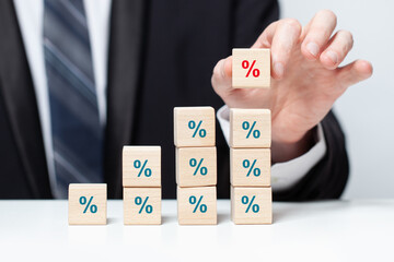 Wooden cubes with green sign percent, business increasing percentage banks mortgage concept