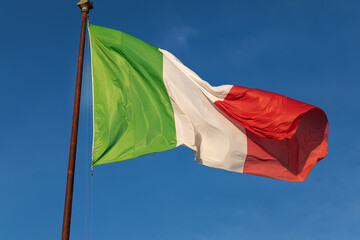 Waving Italian flag on a blue sky