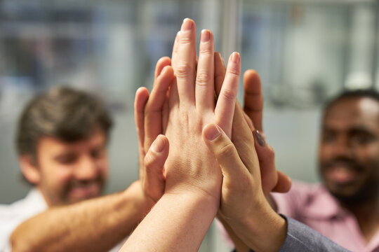Hands of business people high five for team spirit