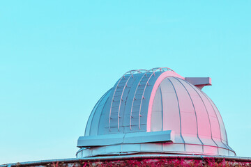 White coral pink dome of a large telescope in the Observatory at sunset on blue pastel sky - Powered by Adobe