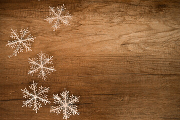 Snowflake on wood, copy space.
White snowflakes on wood background. Christmas decoration.