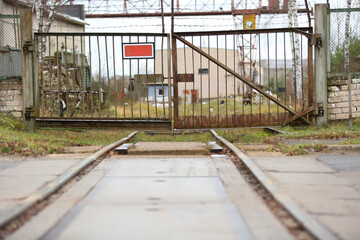 Metal gates to the industrial territory with railway