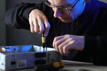 repair of a satellite tuner by a person on a table