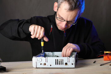 repair of a satellite tuner by a person on a table