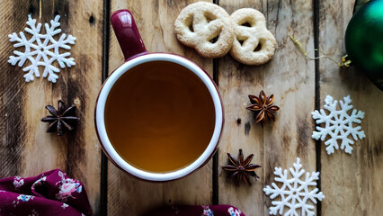 Christmas mood. A cup of aromatic tea and sweet cookies on the table. - 548994009