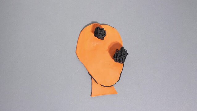 Plasticine claymotion stop motion animation, portrait of Cossack, symbol of freedom. Specific hairstyle is long forelock and mustache developing in wind. Kobzar. Bandura turns into black machine gun