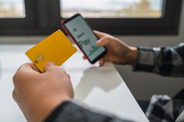 Hands of anonymous person making online electronic payments on your smart phone with your credit card.