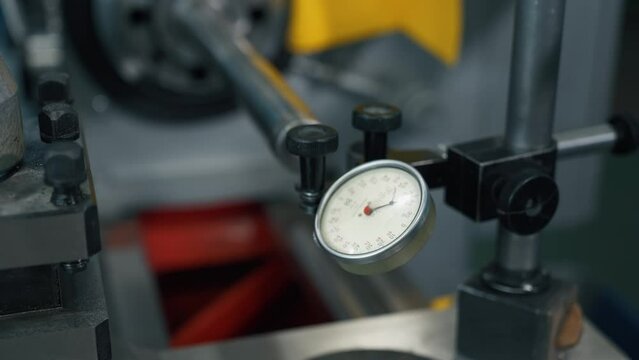Factory production line: indicator micrometer shows the measure. A hands man takes measurements in a factory. Machine tool building. Close-up