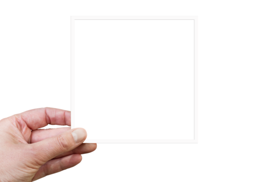 Hand holding a blank square white frame or instant photogrpahy isolated on transparent background