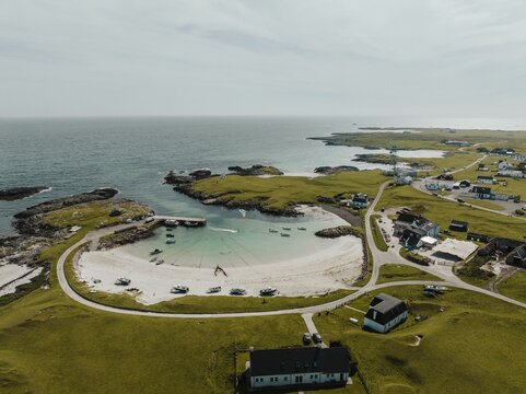 A Kite Surfer In Water Along Tiree Island In Scotland With A Sandy Beach And A Seascape, Aerial