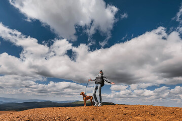 Naklejka na ściany i meble Hiker Man with Vizsla Dog at Mountain Top