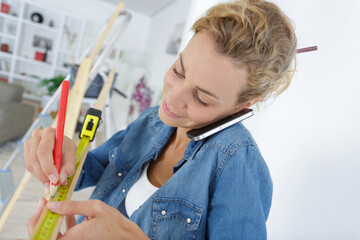 woman marking a wood board