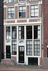 Fototapeta na wymiar Amsterdam Egelantiersgracht Canal Brick House Facade with Sculpted Stone Tablets, Netherlands