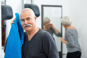 senior man wiping his forehead with towel