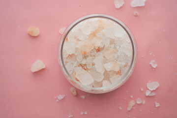 close up of pink rock salt in a bowl on table 