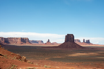 Naklejka premium Nice desert landscape with rocky Monument Valley. It's a sunny summer day with blue sky
