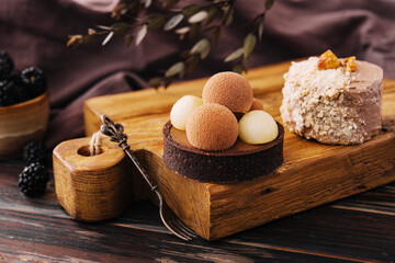 Sweet chocolate tart dessert and mini Kyiv cake