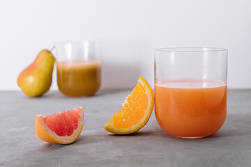 two glasses of orange and pear juice