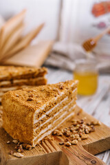Fototapeta na wymiar Slice of sweet honey cake on wooden board