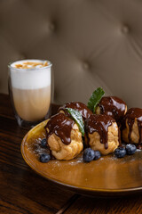delicious profiteroles on a plate in a restaurant
