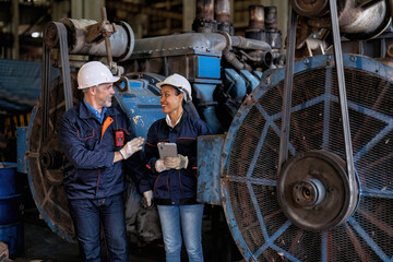 Maintenance engineer and manager in factory use tablet pc checking part available repair machine 
