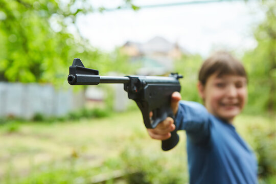 A sports pistol in the hands of a boy's child. Sports shooting. Part of the sports pentathlon.