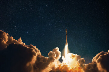 Space rocket successfully takes off into the starry night sky with blast and puffs of smoke....