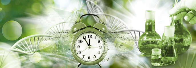Image of an alarm clock from which small particles fly off against the background of an abstract image of DNA chains and chemical flasks