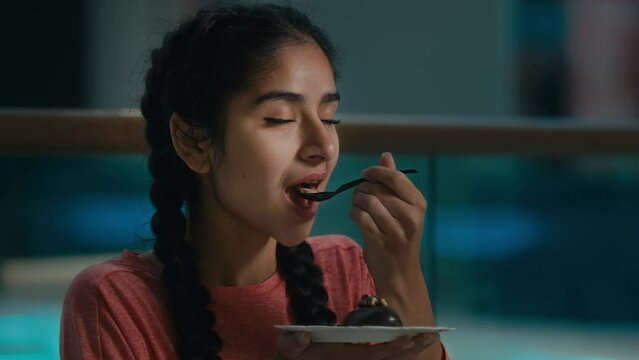 Arabian young woman girl customer visitor eat tasty chocolate cake creamy calorie dessert brownie with gluten sugar dietary vegetarian eclair tasting puncake drink hot coffee tea in cafe restaurant