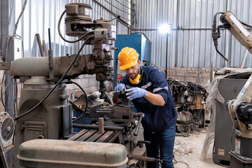 In robotic repair shop engineer use drilling machine fabricate part and vernier caliper measuring