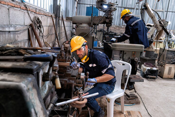 In robotic maintenance repair engineer lathe machine fabricate part and vernier caliper measuring 
