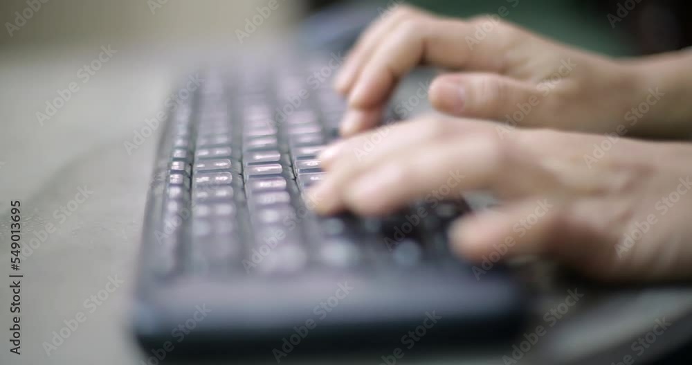 Poster closeup image of a business woman's hands working and typing on computer keyboard on glass table
