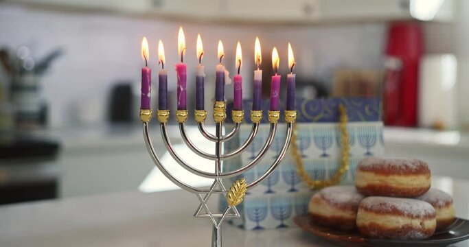 Judaism tradition family religious holiday symbols lighting hanukkiah menorah candles during Hanukkah celebration