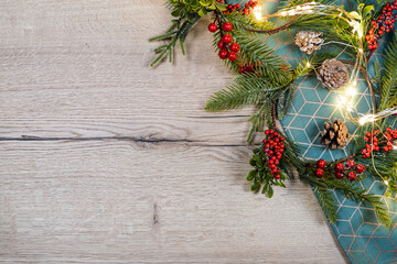 Christmas green, red, gray background. Christmas decoration and candle on cozy wooden background